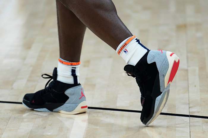 View of Zion Williamson's black, grey, and red Jordan sneakers.